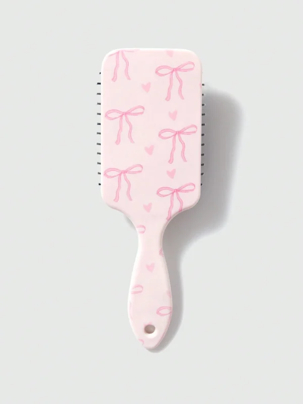 Peigne-coussin nœud papillon rose