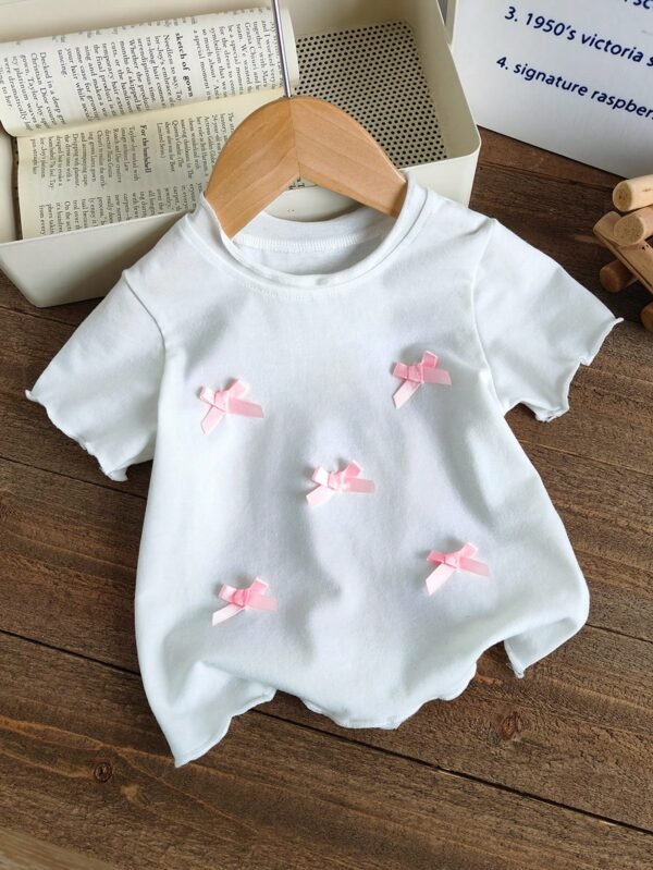 Top tricot rose blanc volants